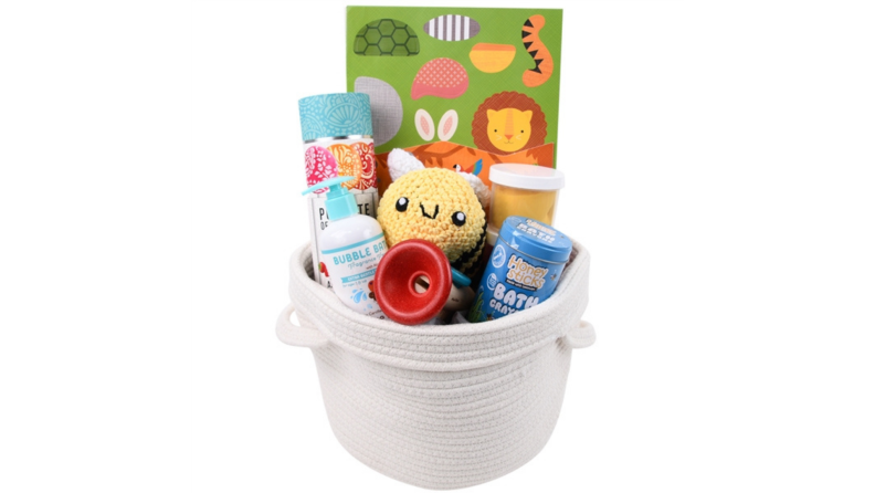 This toddler-friendly white Easter basket includes a stuffed toy bumble bee, bubble bath, and bath crayons.