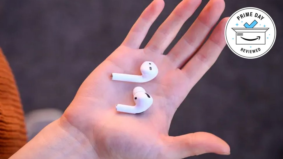 White bluetooth headphones in hand