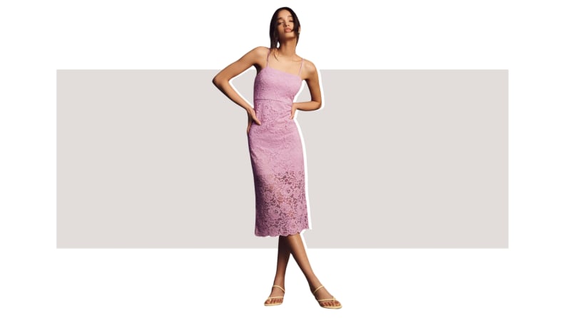 A model wearing a lilac-colored midi dress made from lace fabric.