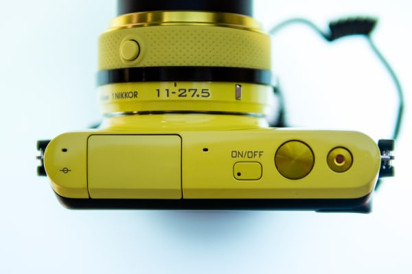 The Nikon 1 S2 comes in yellow, red, black, or white.