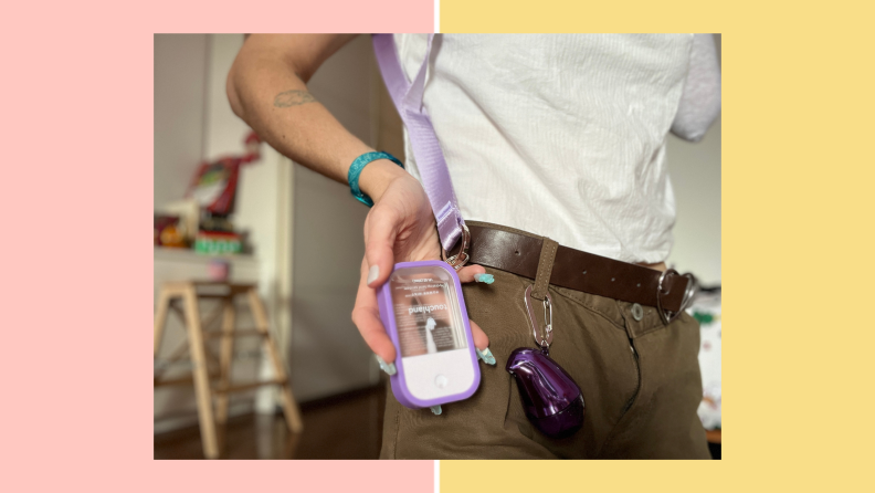 Author holding a purple Touchland hand sanitizer.