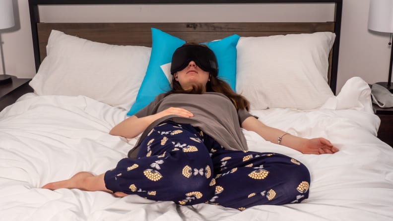 A person falls asleep in bed with the Jabees Serenity sleep mask.