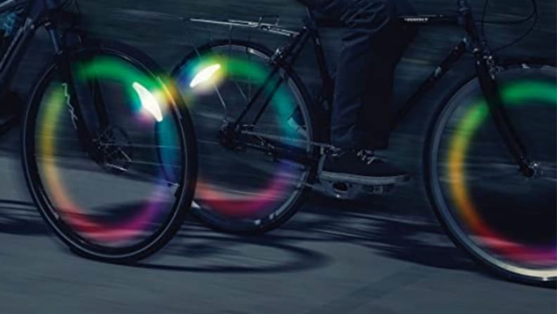 A series of lit-up bike wheels with spoke lights.