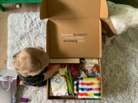 A child opens a box of Lovevery toys