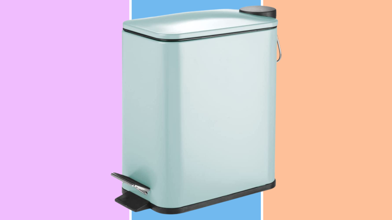A blue step trashcan against a purple, blue, and orange background.