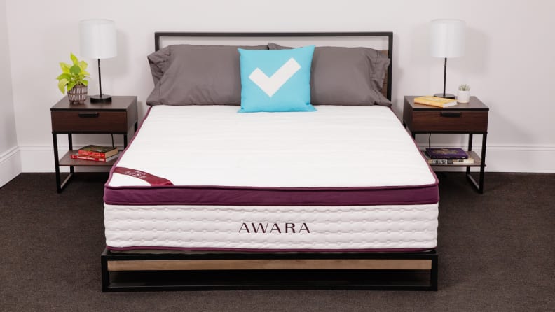 The Awara mattress appears in a bedroom with bedside tables on either side.