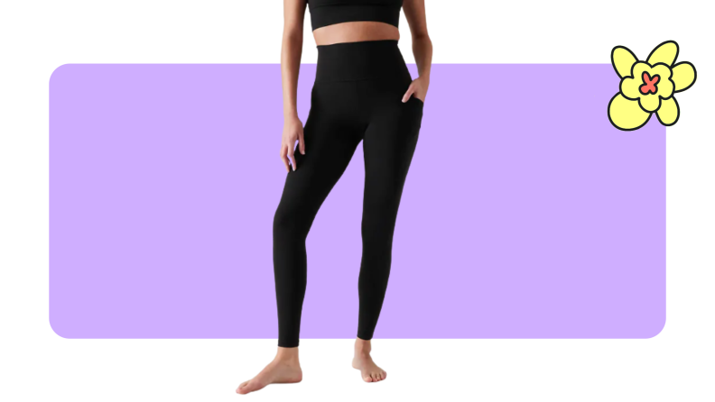 A model displaying a pair of black Athleta Salutation Stash leggings with a cropped worktop.