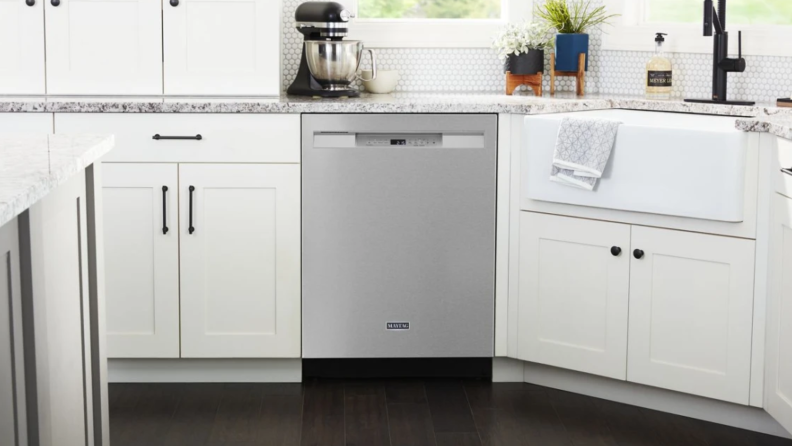 The Maytag MDB4949SKZ dishwasher in a white kitchen.