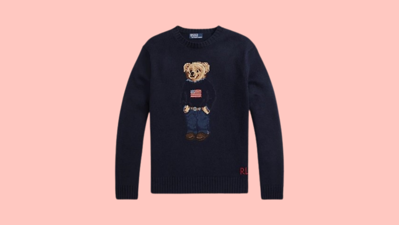 A navy sweater knit with a pattern of the Polo Bear wearing an American Flag sweater with jeans and a belt.