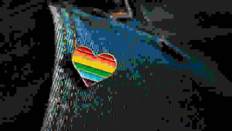 Rainbow color lgbt heart badge on jeans. Closeup photo. Freedom concept parade.