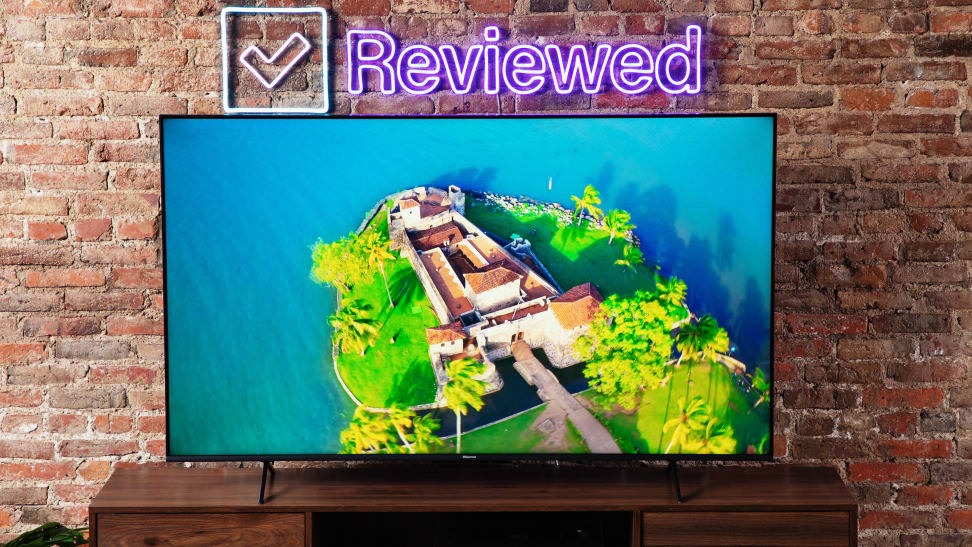 A television set in a living room with a display showing an aerial view of an island.