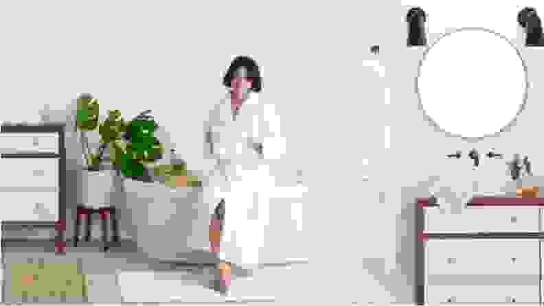 A woman in a white bathrobe.