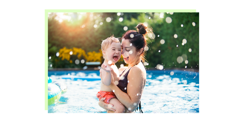 A woman embracing a child with special needs in a pool.