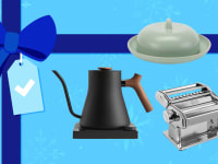 A teapot, butter dish, and pasta maker on a blue gift background