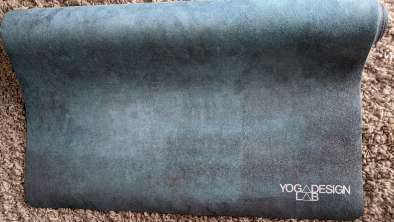 Yoga Design Lab Combo Mat resting on a carpeted floor