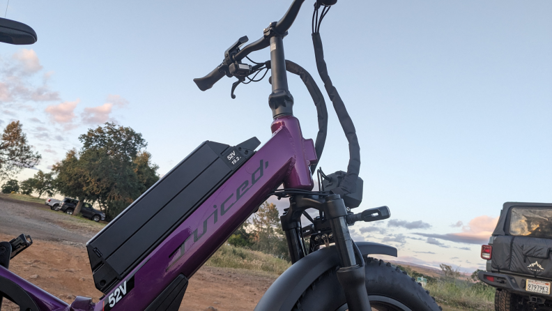 A close-up of a purple, Juiced JetCurrent Pro e-bike, outside.