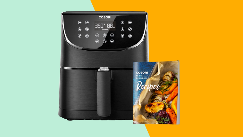 A black corsori air fryer with corresponding recipe book against a mint green/gold background.