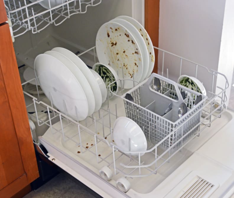 Dirty dishes on the lower rack before the wash