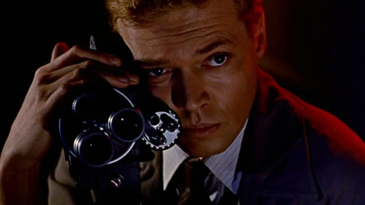 A man holding a camera, in a scene from the 1960 film, "Peeping Tom."