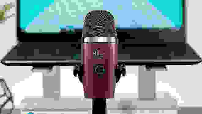 A microphone in front of a laptop.