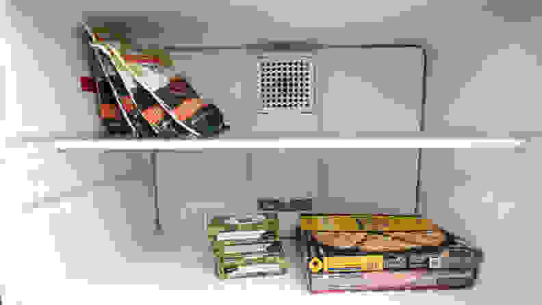 A shot of the interior of the GE GTS22KGNRBB top-freezer refrigerator's freezer, stocked with food for scale.