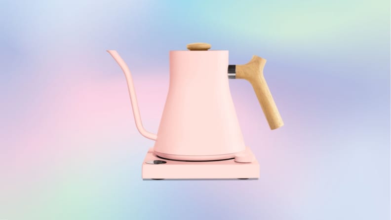A pastel pink gooseneck electric kettle against a pastel rainbow gradient background.