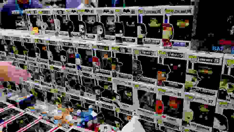 A collection of sealed Funko Pops sitting on a department store shelf.