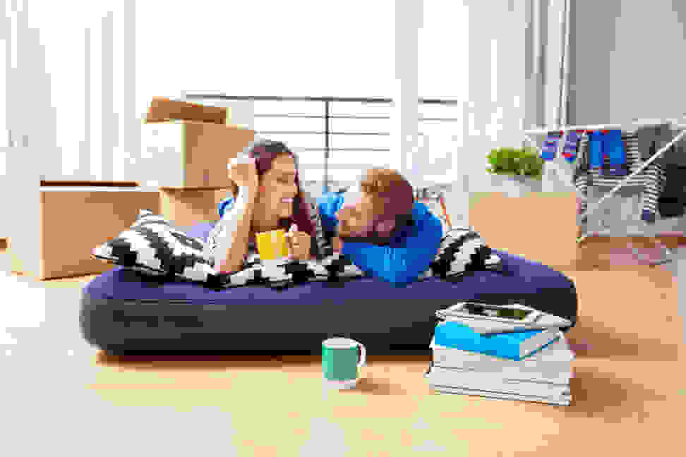 couple on an air mattress after moving