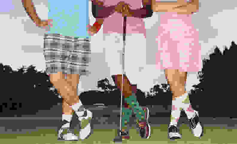 Three golfers in golf outfits