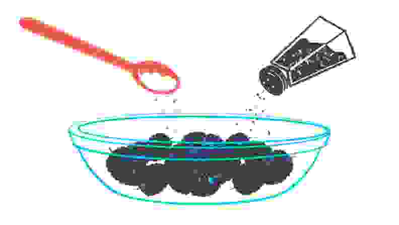 An illustration of blackberries in a bowl being doused in black pepper.