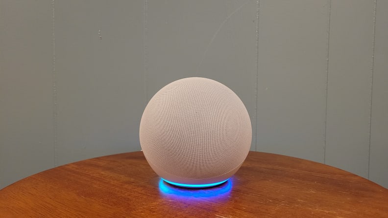 Amazon Echo (4th gen) smart speaker sits on a wood table