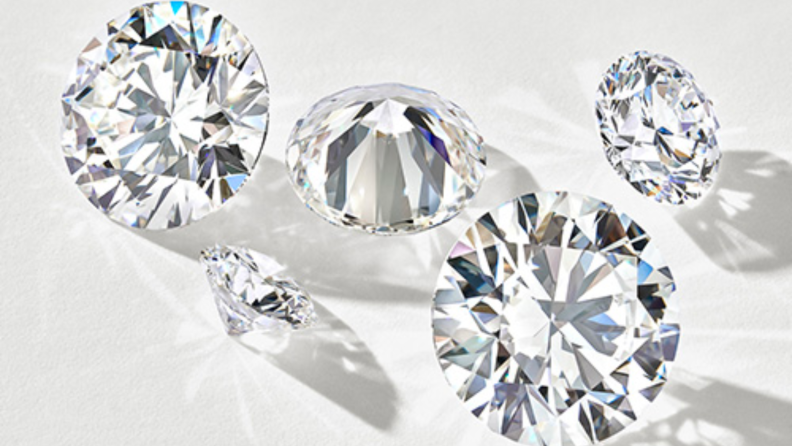 An image of several diamonds of varying cuts, shapes, and sizes.