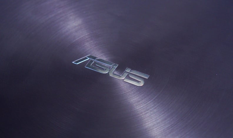 The back of the lid has a brushed aluminum finish in a radial pattern that emphasizes the logo.