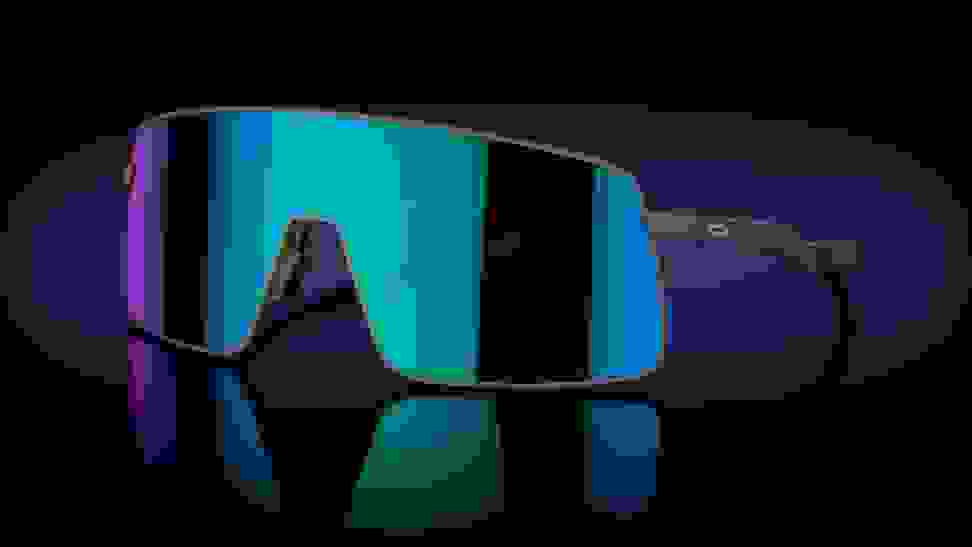 A pair of wide, blue-and-violet-tinted oversized Oakleys against a black backdrop.