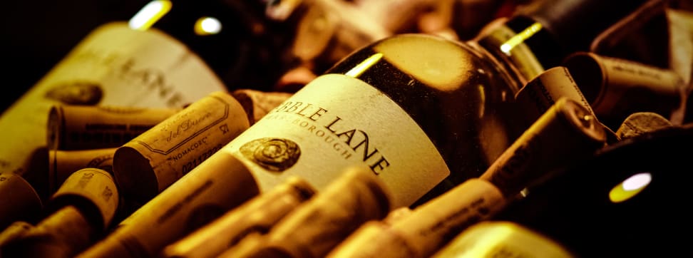 A bottle of wine with corks.