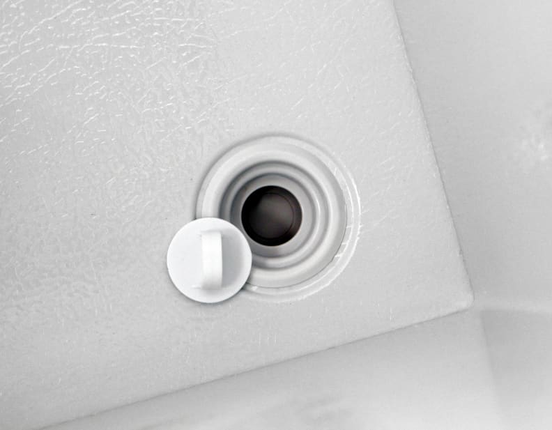 A small drain is found inside the Kenmore 16542 near the front right corner.