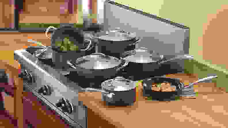 Several Cuisinart GreenGourmet cookware pieces sitting on a range and kitchen counter