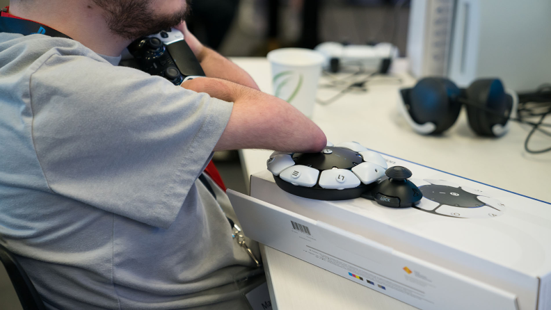 Person resting elbow on top of the PS5 Access Controller.