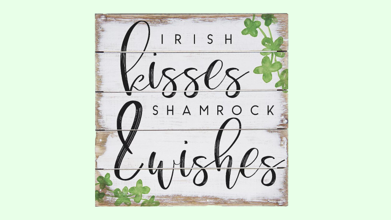 Rustic wall art that reads 'Irish Kisses and Shamrock wishes.'