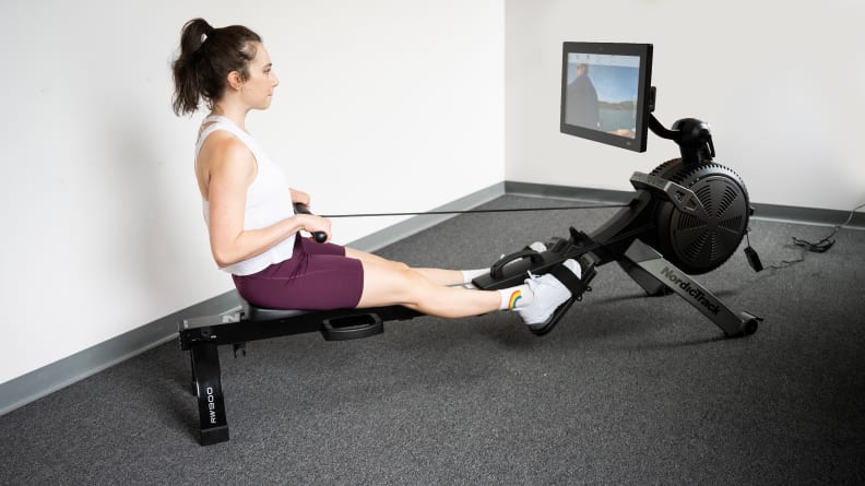 woman rowing on nordictrack rw900 machine.