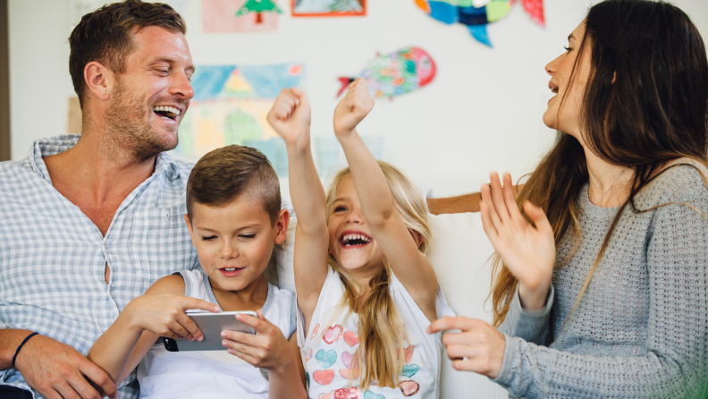 A family laughs together over games