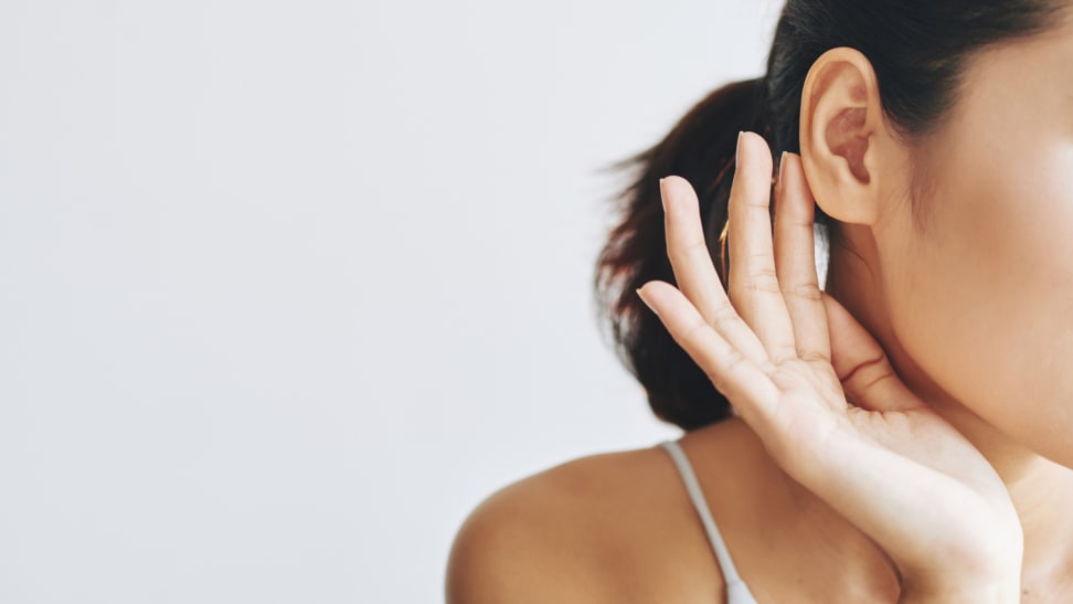 Person cupping their hand around their ear