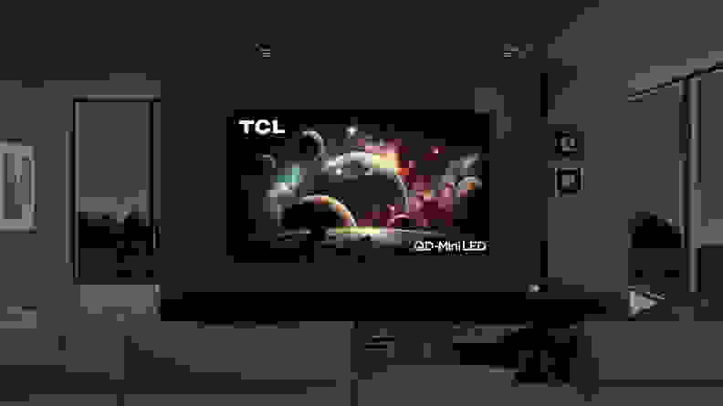 The 115-inch TCL QM89 mini-LED TV taking up most of the space on a wall in a modern living room setting