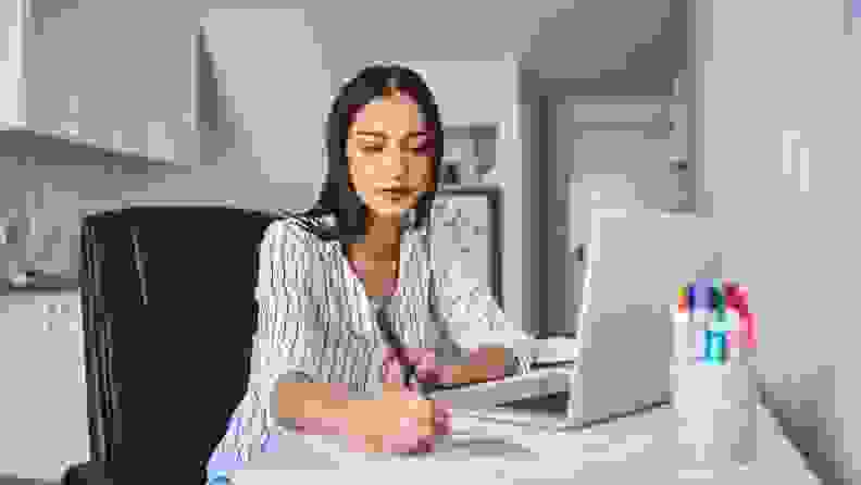 a woman works at her desk working