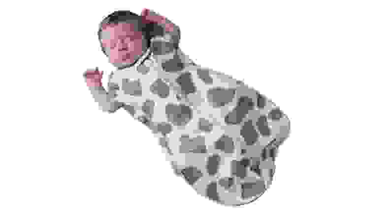 A sleeping baby in a printed sleep sack