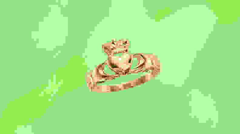 A gold ring in front of a green background.