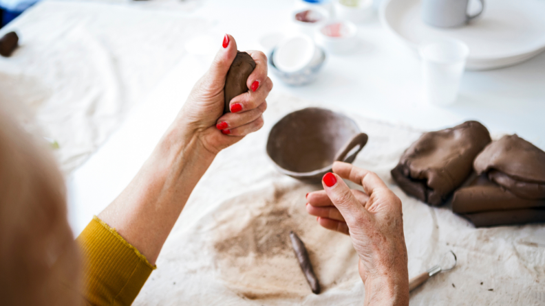 Person molding clay with their hands