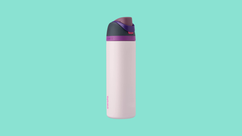 An Owala stainless steel water bottle with a purple and black cap on a dark teal background.