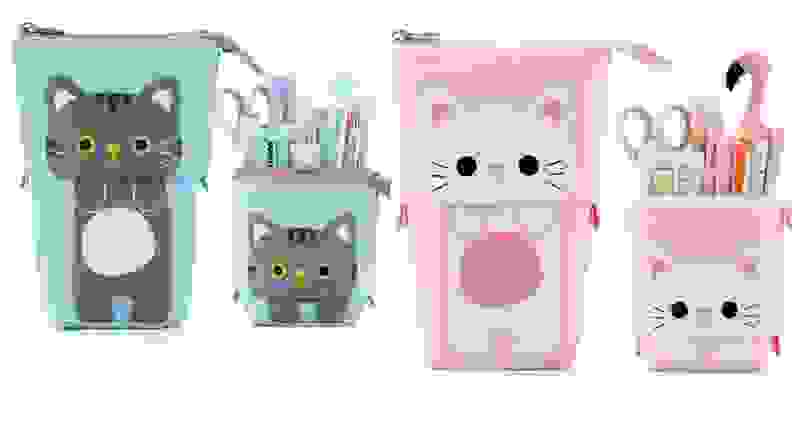 Pink and blue cat-themed pencil pouches holding school supplies.