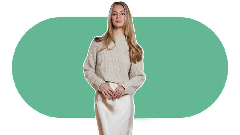 woman wearing cream sweater and slip on white and green background